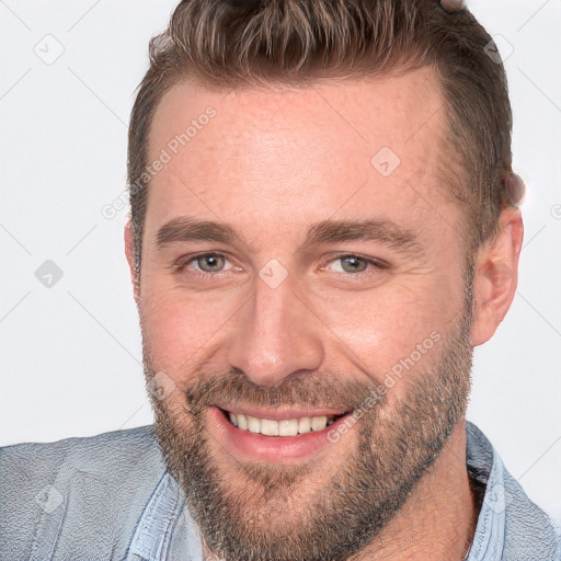 Joyful white adult male with short  brown hair and brown eyes