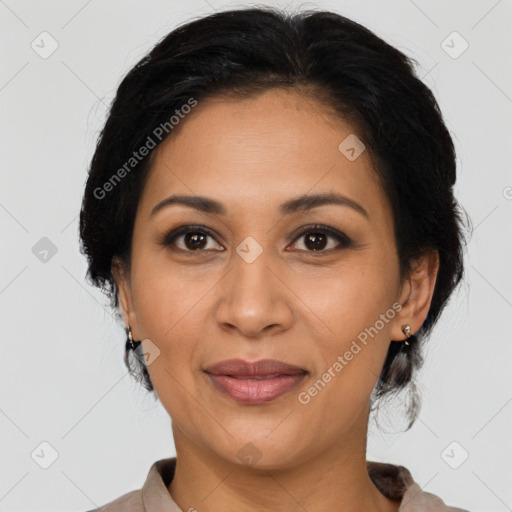 Joyful latino adult female with medium  brown hair and brown eyes