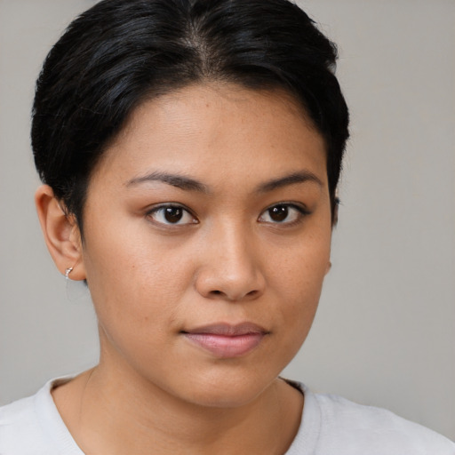 Joyful latino young-adult female with short  brown hair and brown eyes