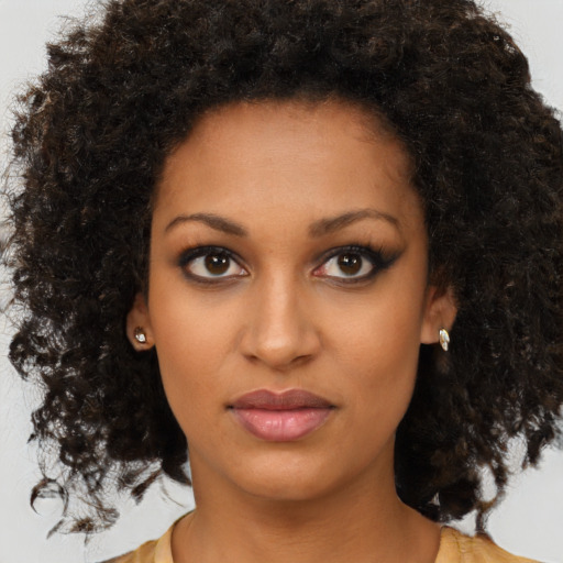 Neutral black young-adult female with medium  brown hair and brown eyes