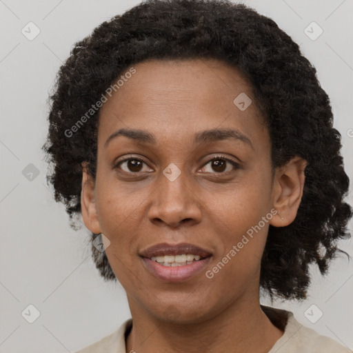 Joyful black adult female with short  brown hair and brown eyes