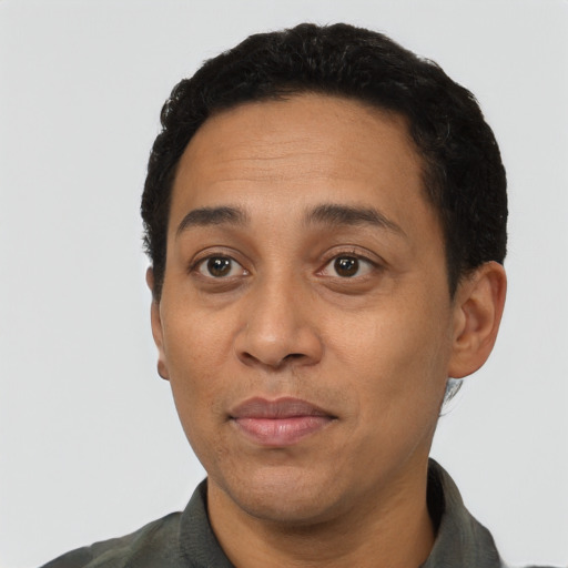 Joyful latino adult male with short  black hair and brown eyes
