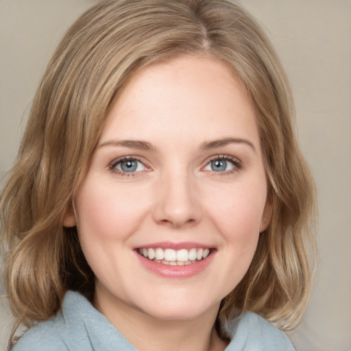 Joyful white young-adult female with medium  brown hair and blue eyes