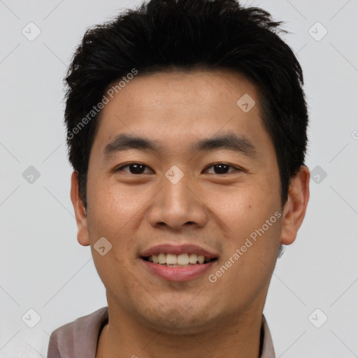 Joyful asian young-adult male with short  black hair and brown eyes