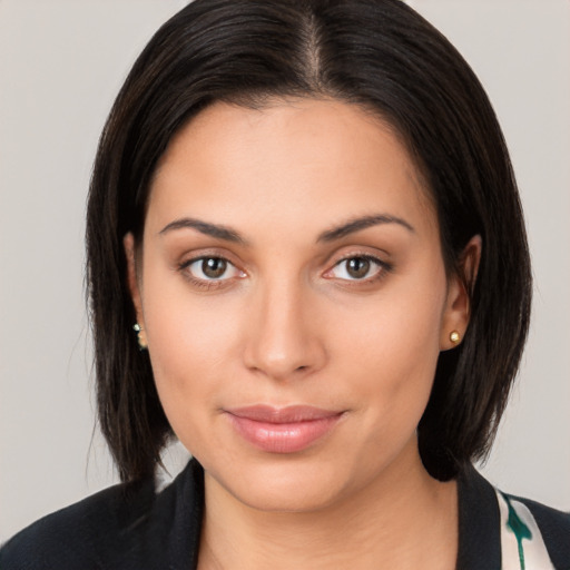 Joyful latino young-adult female with medium  brown hair and brown eyes