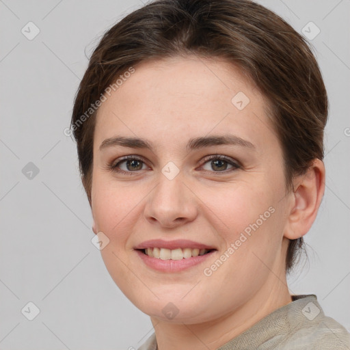 Joyful white young-adult female with short  brown hair and grey eyes