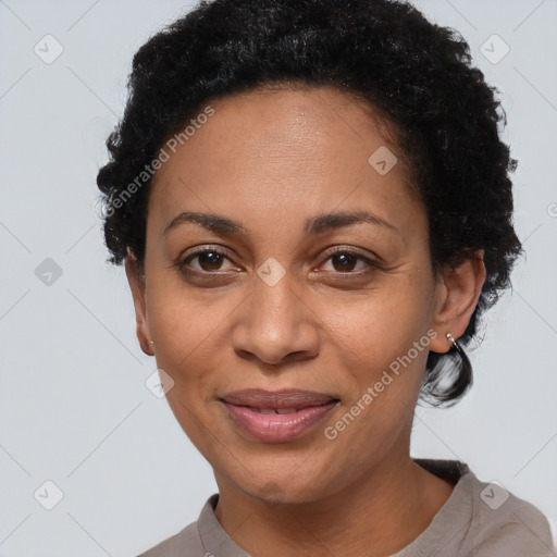 Joyful black adult female with short  black hair and brown eyes