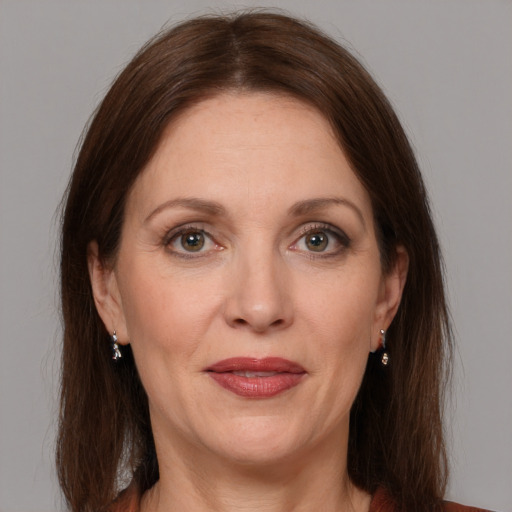 Joyful white adult female with medium  brown hair and grey eyes