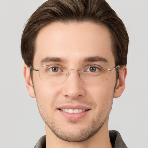 Joyful white young-adult male with short  brown hair and grey eyes