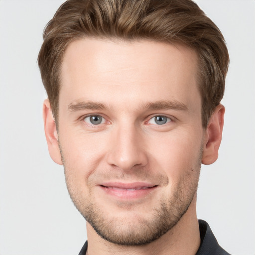 Joyful white young-adult male with short  brown hair and grey eyes