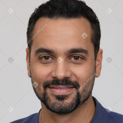 Joyful latino young-adult male with short  black hair and brown eyes