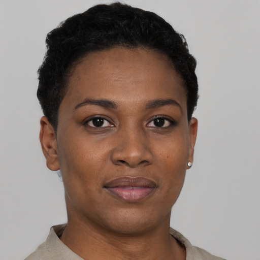 Joyful black young-adult female with short  black hair and brown eyes