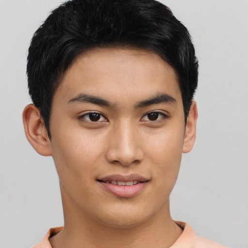 Joyful asian young-adult male with short  brown hair and brown eyes