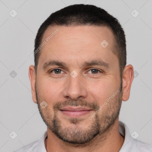 Joyful white adult male with short  brown hair and brown eyes