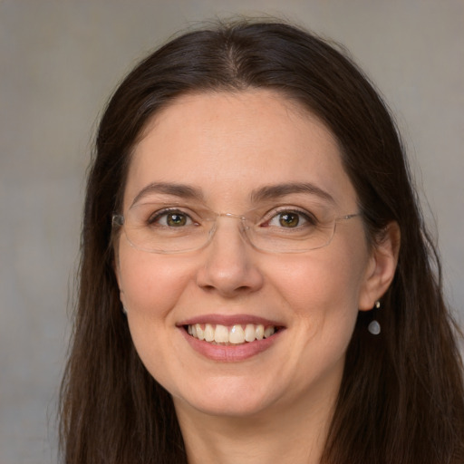 Joyful white adult female with long  brown hair and grey eyes