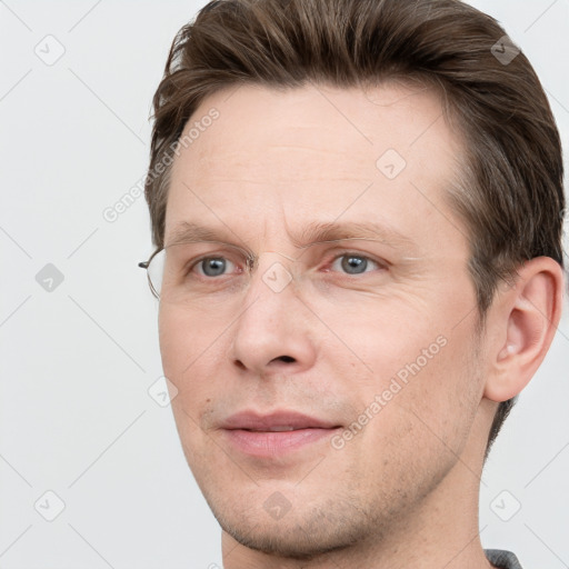 Joyful white adult male with short  brown hair and grey eyes