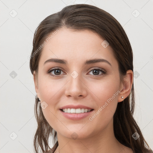 Joyful white young-adult female with long  brown hair and grey eyes