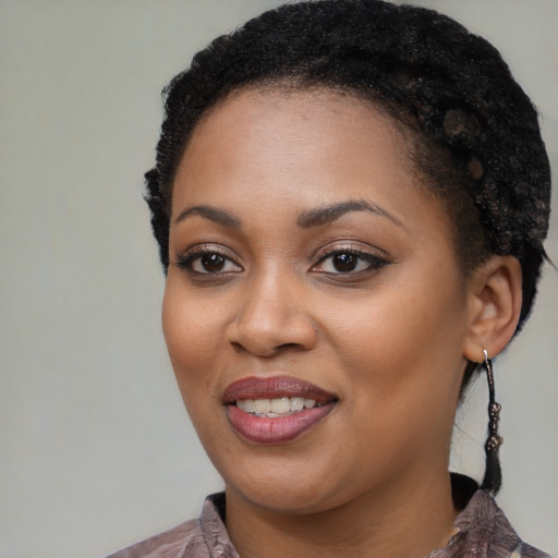 Joyful black young-adult female with medium  black hair and brown eyes