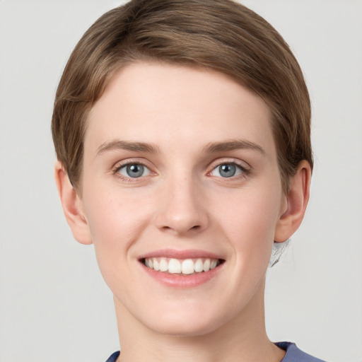 Joyful white young-adult female with short  brown hair and grey eyes