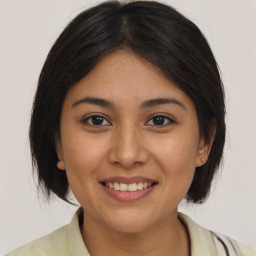 Joyful asian young-adult female with medium  brown hair and brown eyes