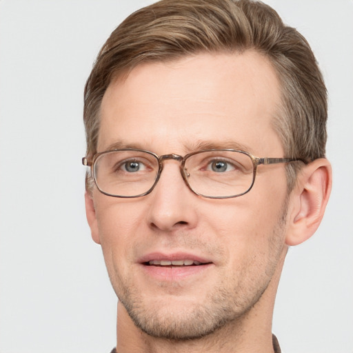 Joyful white adult male with short  brown hair and grey eyes