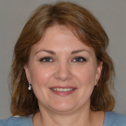 Joyful white adult female with medium  brown hair and brown eyes