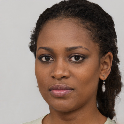 Neutral black young-adult female with medium  brown hair and brown eyes