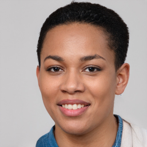 Joyful black young-adult female with short  black hair and brown eyes