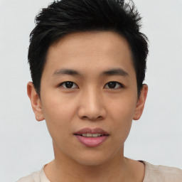 Joyful asian young-adult male with short  black hair and brown eyes