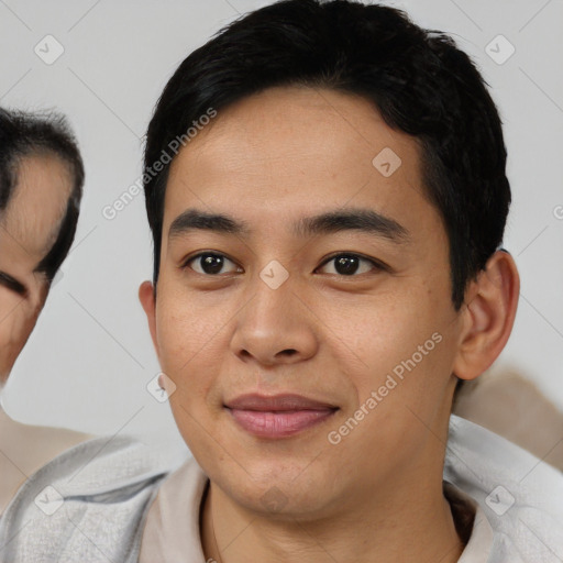 Joyful asian young-adult male with short  black hair and brown eyes