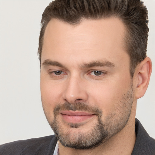 Joyful white adult male with short  brown hair and brown eyes