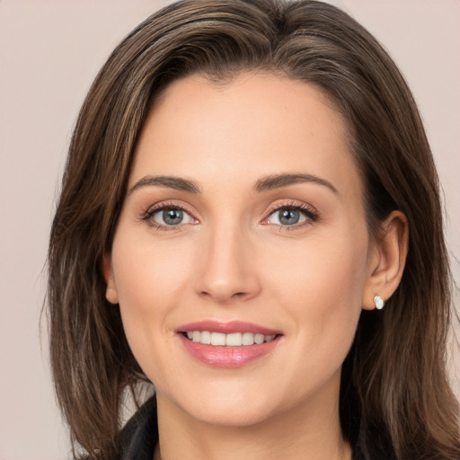 Joyful white young-adult female with long  brown hair and brown eyes