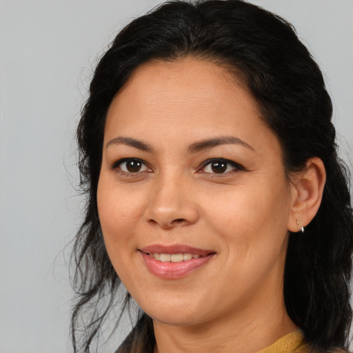 Joyful latino adult female with medium  brown hair and brown eyes
