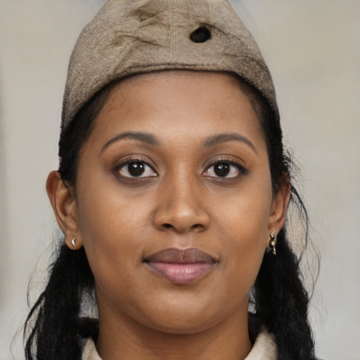 Joyful black young-adult female with medium  brown hair and brown eyes