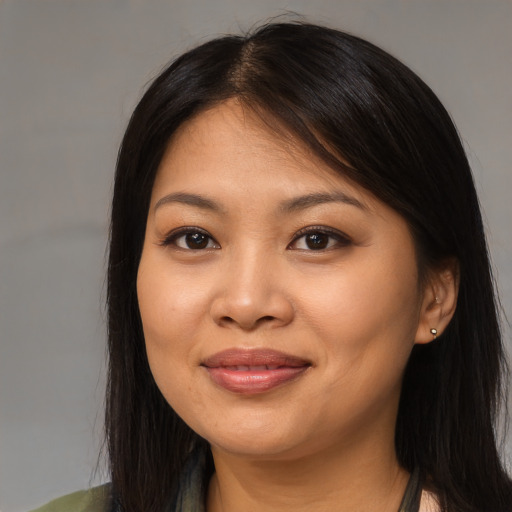 Joyful asian young-adult female with long  brown hair and brown eyes
