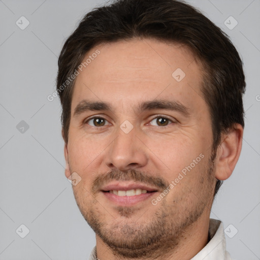 Joyful white adult male with short  brown hair and brown eyes