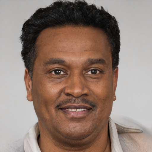Joyful black adult male with short  brown hair and brown eyes