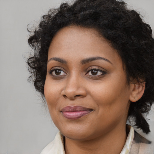 Joyful black young-adult female with medium  brown hair and brown eyes