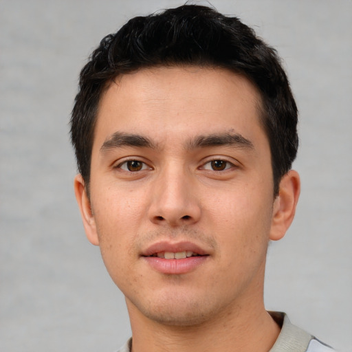 Joyful white young-adult male with short  black hair and brown eyes