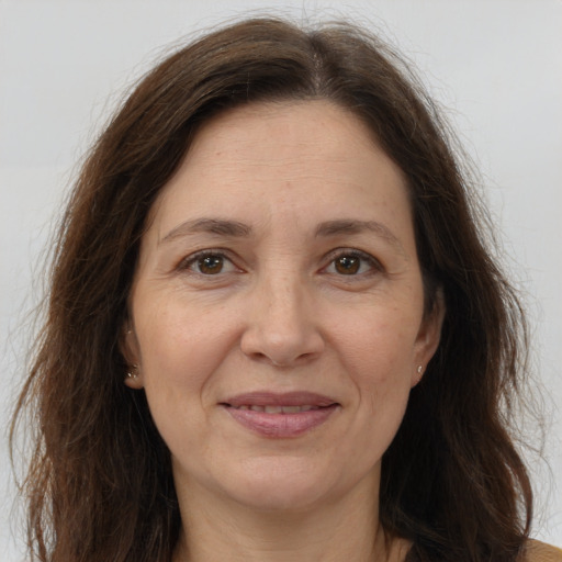 Joyful white adult female with long  brown hair and brown eyes