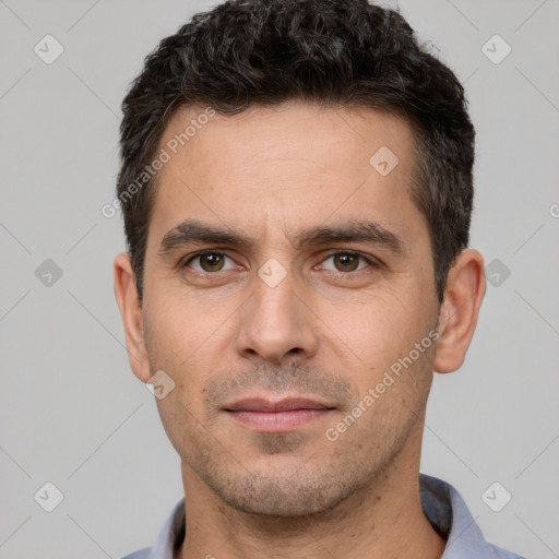 Joyful white young-adult male with short  black hair and brown eyes