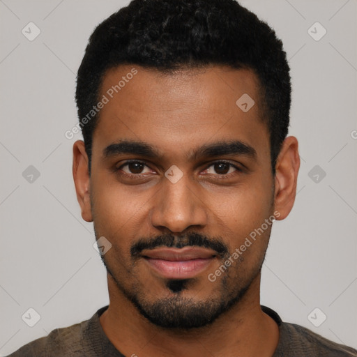 Joyful black young-adult male with short  black hair and brown eyes