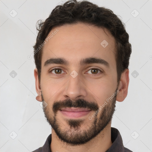 Joyful white young-adult male with short  black hair and brown eyes