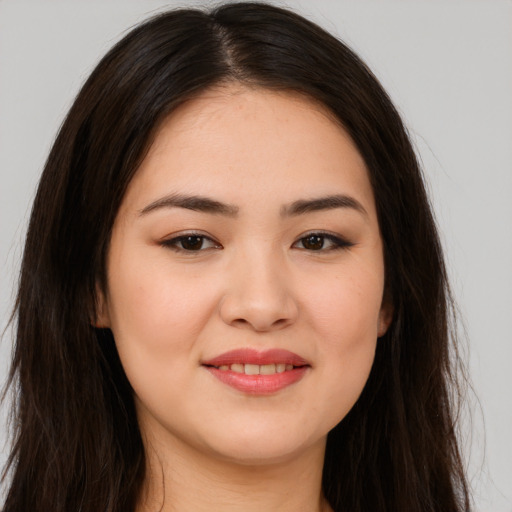 Joyful asian young-adult female with long  brown hair and brown eyes