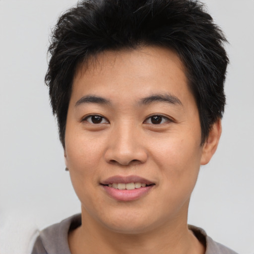 Joyful asian young-adult male with short  brown hair and brown eyes
