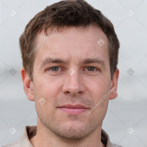 Joyful white adult male with short  brown hair and grey eyes