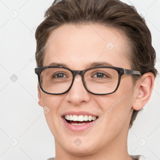 Joyful white young-adult female with short  brown hair and grey eyes