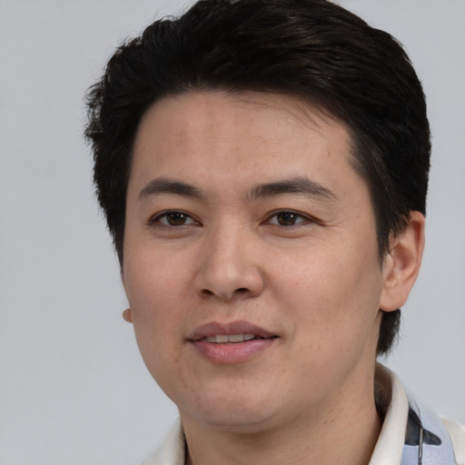 Joyful white young-adult male with short  black hair and brown eyes