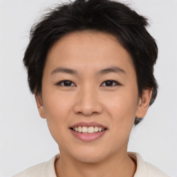 Joyful asian young-adult female with short  brown hair and brown eyes