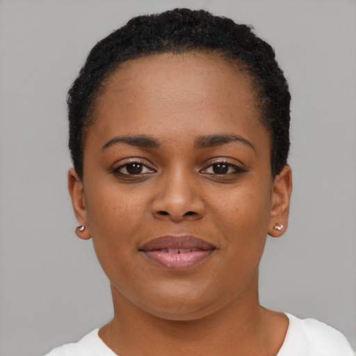 Joyful black young-adult female with short  black hair and brown eyes